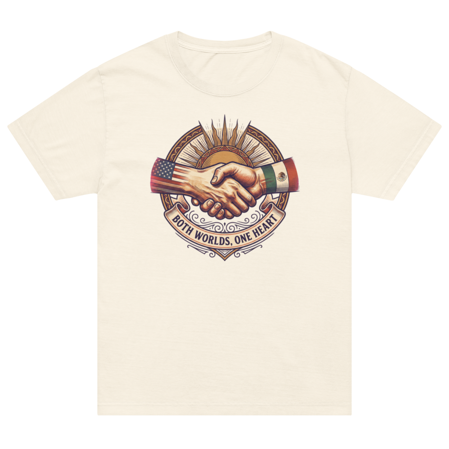 An off-white cream short-sleeve t-shirt with a central graphic of two shaking hands, one arm decorated with the Mexican flag and the other with the US flag, under a sunburst with the text 'BOTH WORLDS, ONE HEART'.