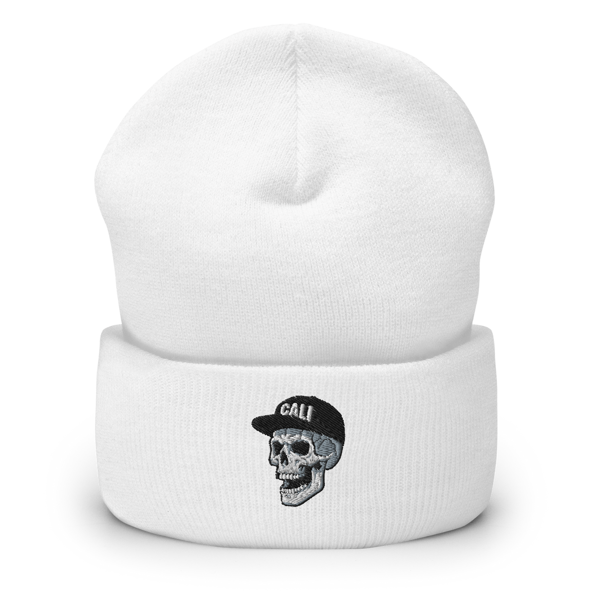 White beanie with a black embroidered skull wearing a CALI baseball hat.