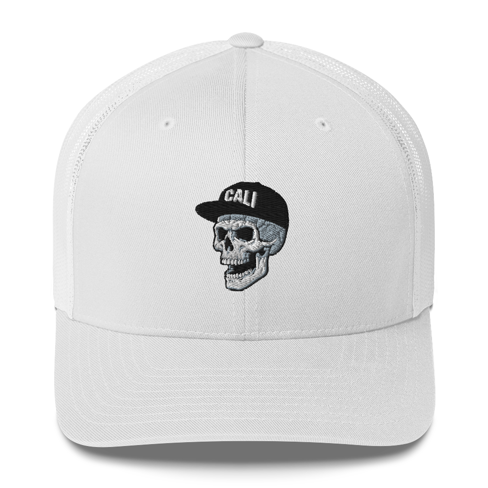 A white structured trucker-style cap with a curved brim, featuring an embroidered skull wearing a black cap with the word 'CALI' on the front.