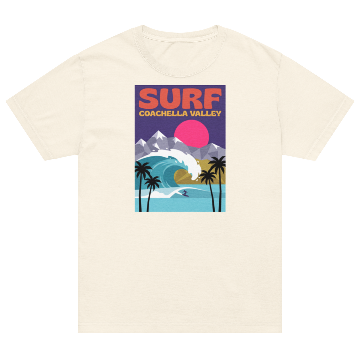 An off-white short-sleeve crewneck t-shirt featuring a colorful retro-style graphic print on the front that reads 'SURF COACHELLA VALLEY' above an illustration of a wave, mountains, palm trees, and a pink sun.