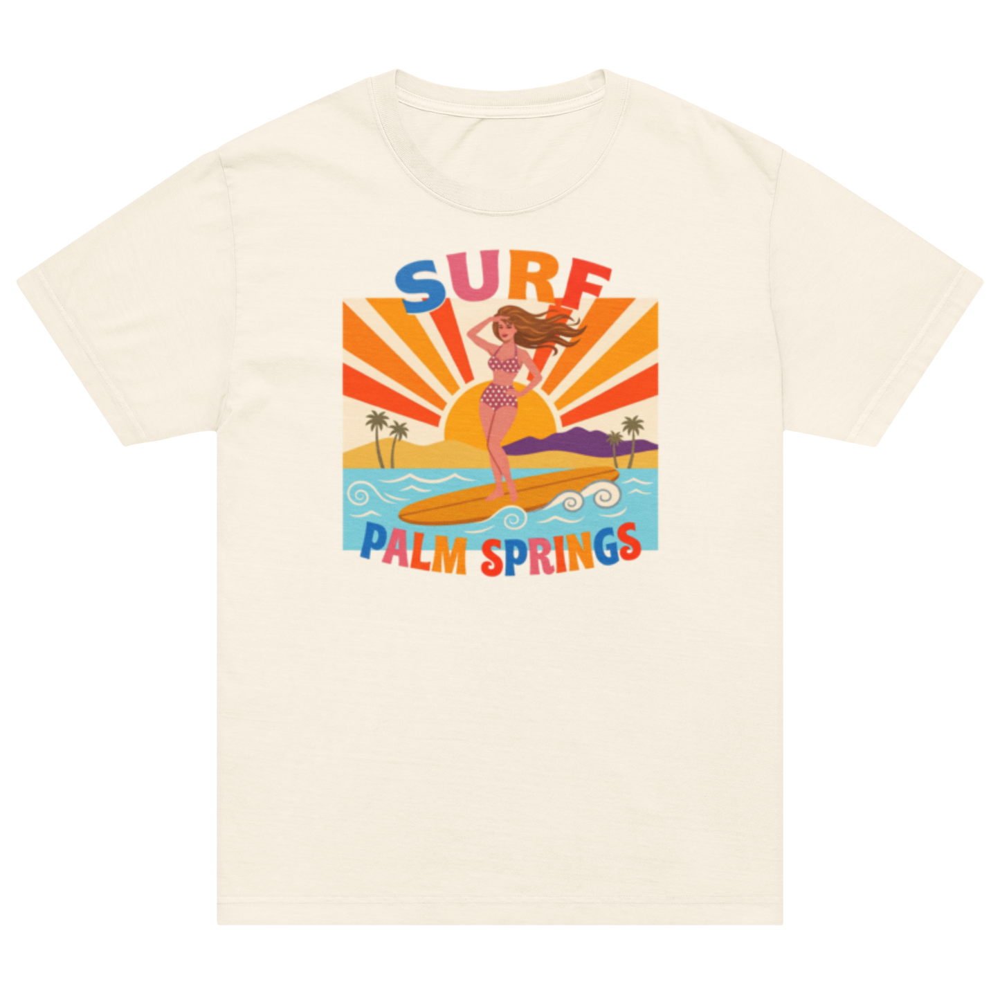 An off-white short-sleeve t-shirt with a colorful retro graphic on the front depicting a woman surfing at Palm Springs with the text 'SURF PALM SPRINGS'.