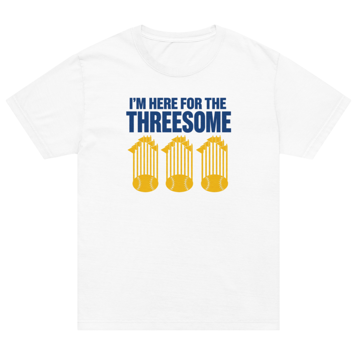 A white short-sleeve crewneck t-shirt featuring a blue and yellow graphic print on the front. The graphic reads 'I'M HERE FOR THE THREESOME' in blue text above three yellow baseball championship trophy silhouettes.
