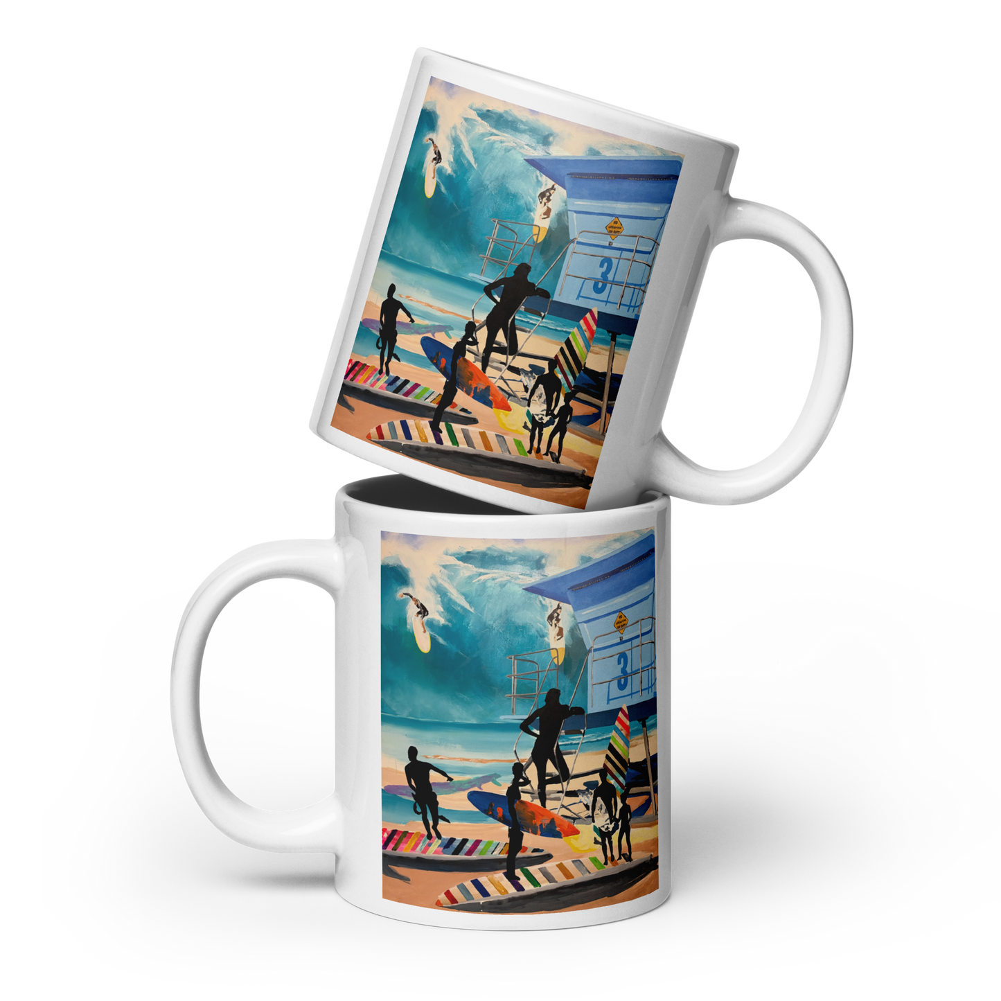 Two white ceramic mugs stacked and overlapping, each printed with a colorful beach scene illustration featuring surfers, a lifeguard tower, and ocean waves. Daniel Maltzman original design.