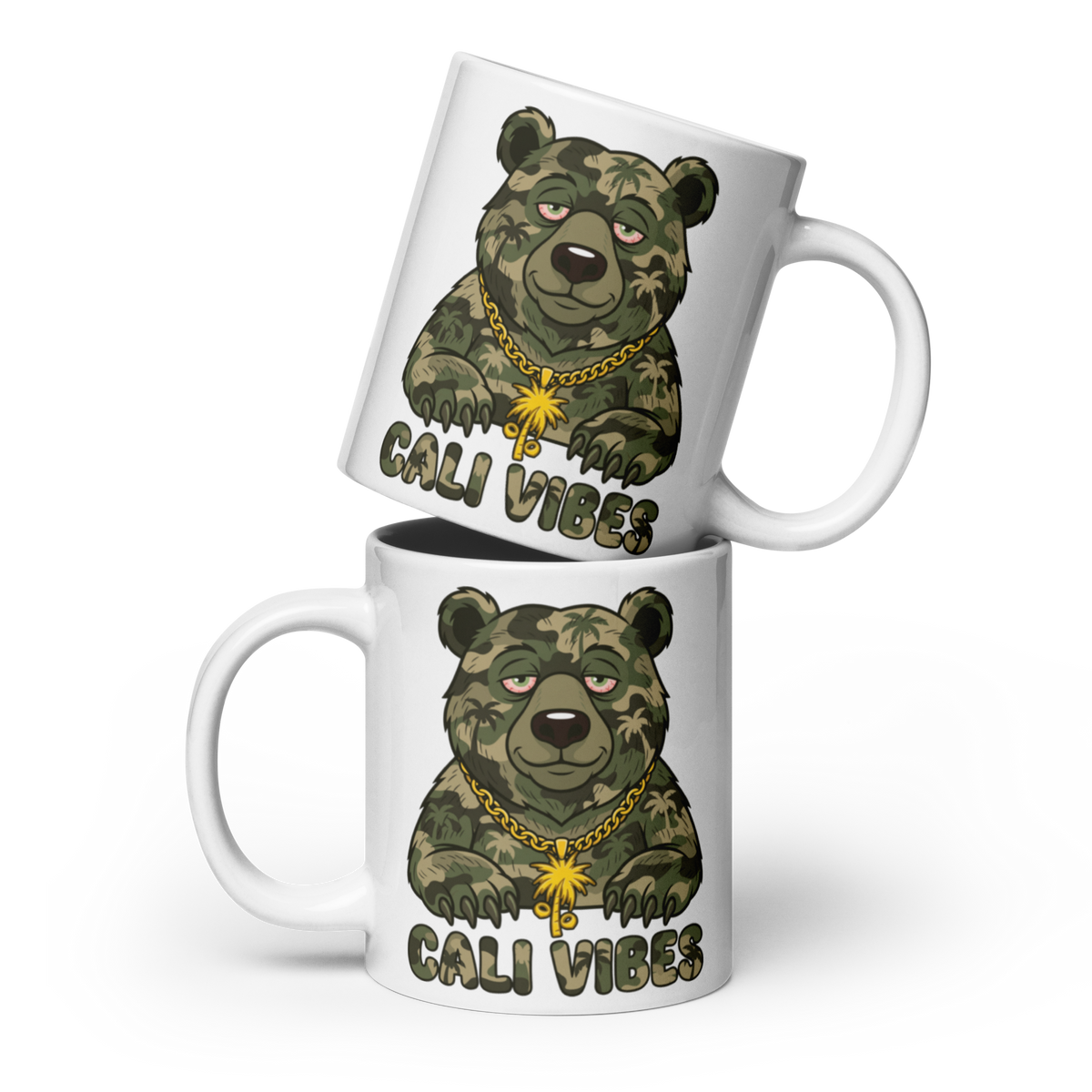 Two white ceramic mugs stacked diagonally, featuring a cartoon grizzly bear printed in green camouflage with a gold chain and the text 'CALI VIBES' below it.