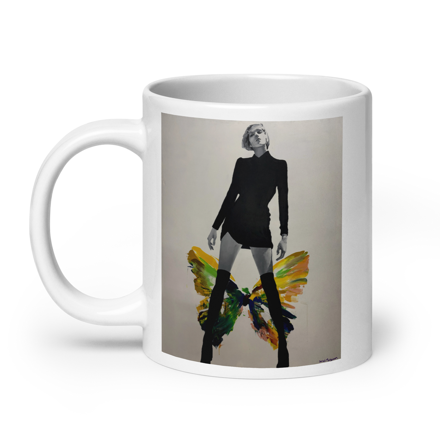 A white ceramic mug featuring a printed graphic of a woman in a black outfit with colorful butterfly wings, set against a plain white background. Daniel Maltzman artist.