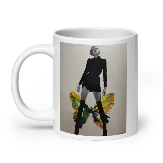 A white ceramic mug featuring a printed graphic of a woman in a black outfit with colorful butterfly wings, set against a plain white background. Daniel Maltzman artist.