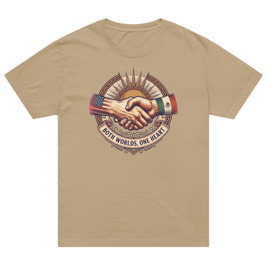 A beige crewneck t-shirt featuring a central graphic of a handshake with the American and Mexican flags and the text 'BOTH WORLDS, ONE HEART'.