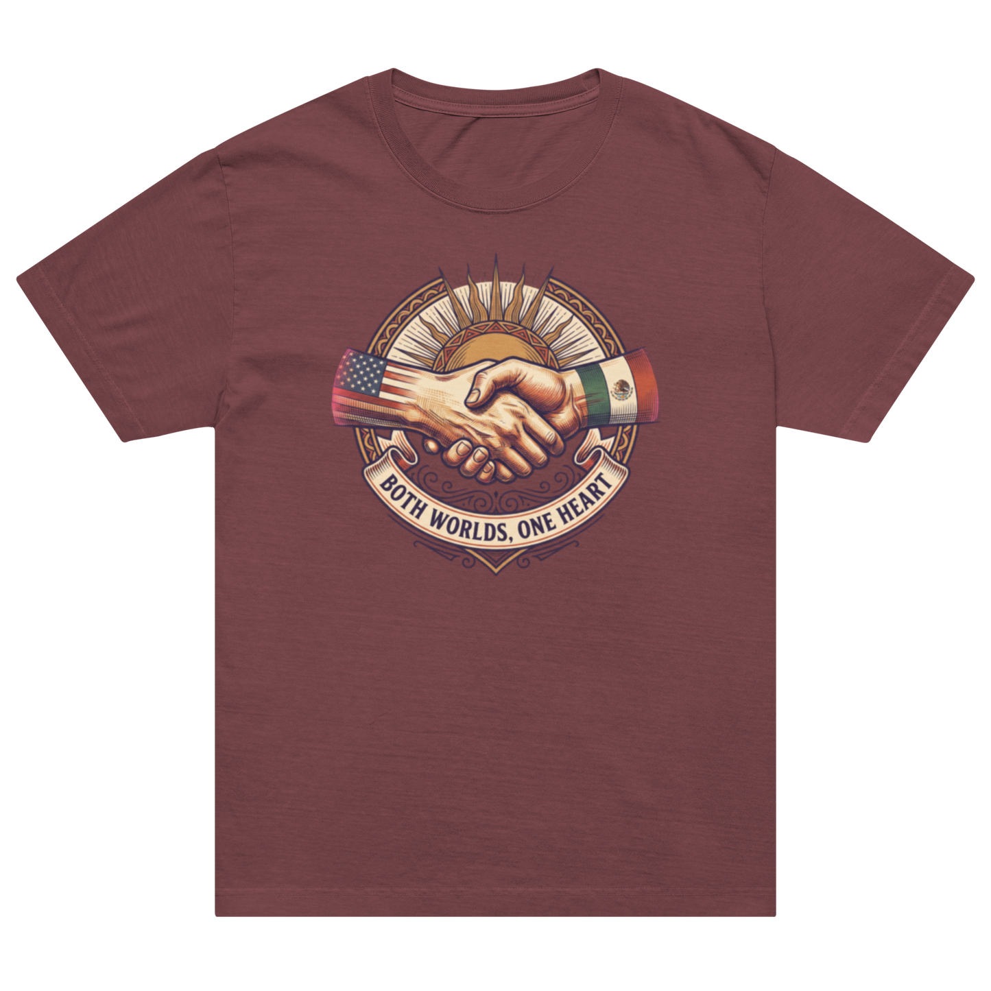 A maroon short-sleeve crewneck t-shirt featuring a central graphic of two shaking hands, one wearing an American flag sleeve and the other wearing a Mexican flag sleeve, with the text 'BOTH WORLDS, ONE HEART' below.
