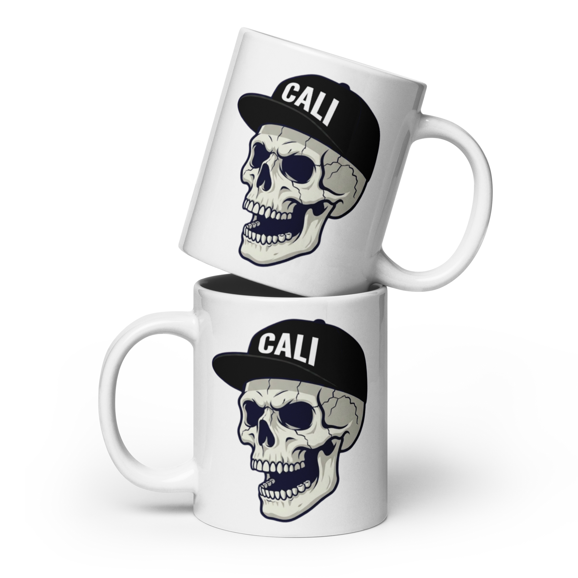 Two stacked white ceramic mugs with a graphic of a skull wearing a black baseball cap that says 'CALI' in white letters, shown on a clean white background.