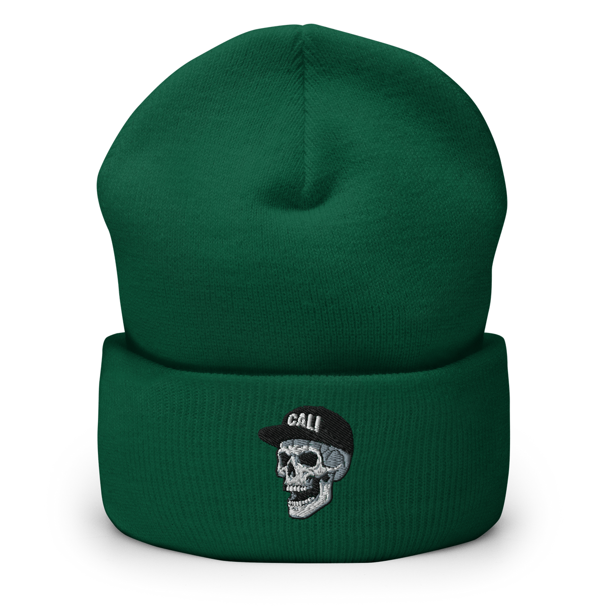 A dark green knit beanie hat with a folded cuff, featuring an embroidered skull wearing a black cap with the word 'CALI' in white on the front.