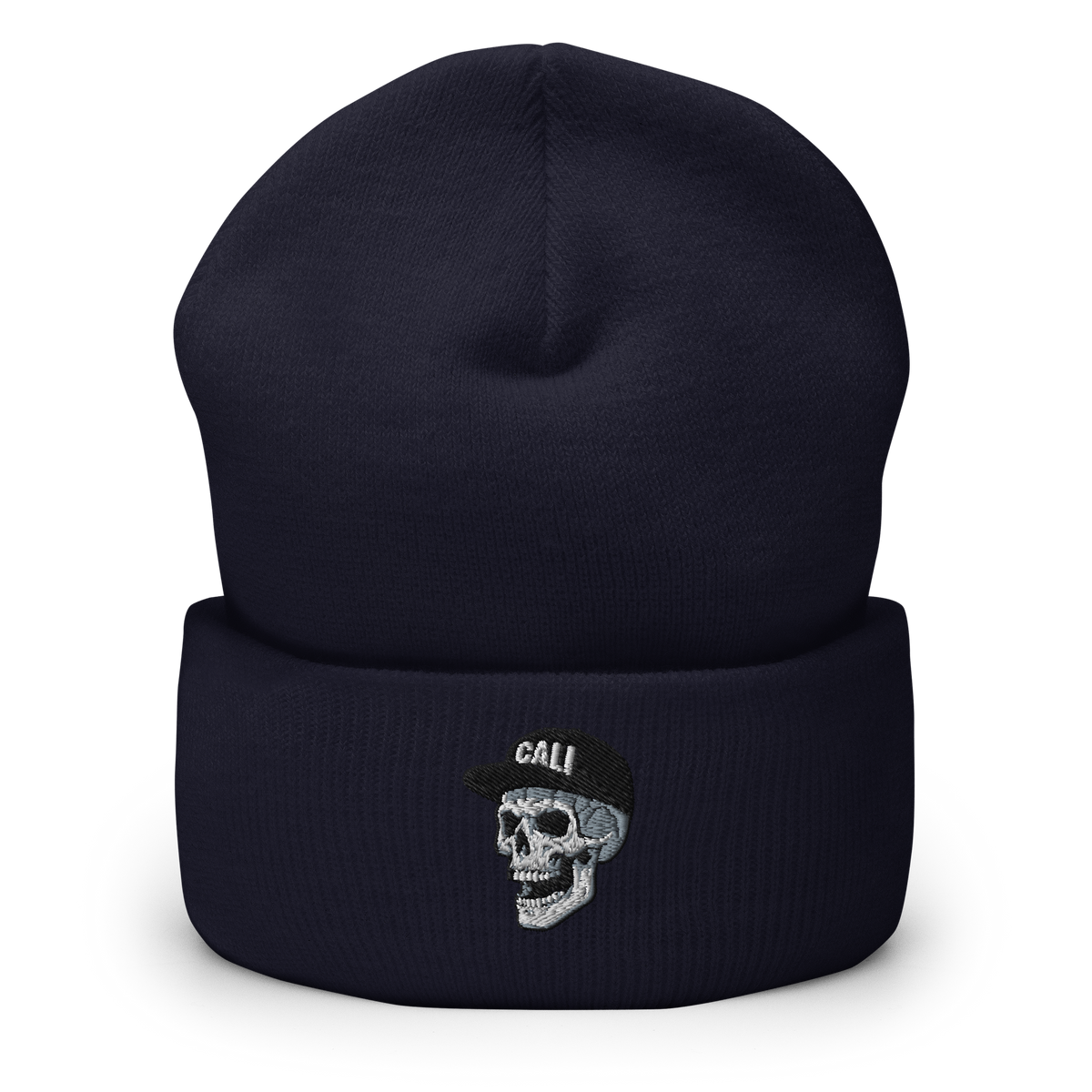 A dark navy blue knit beanie hat with a folded cuff, featuring an embroidered skull wearing a black cap with the word 'CALI' in white on the front.