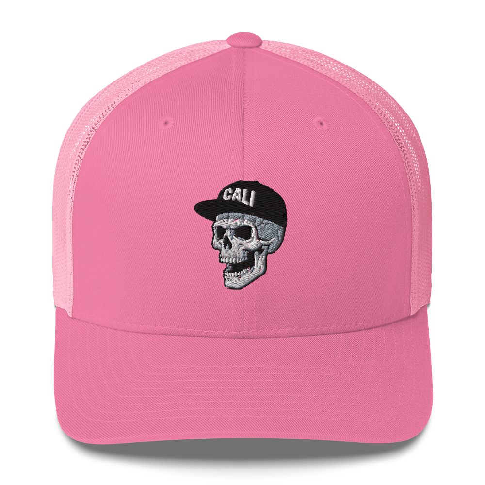 A pink trucker-style cap with a curved brim, featuring an embroidered skull wearing a black cap with the word 'CALI' on the front, set against a plain white background.
