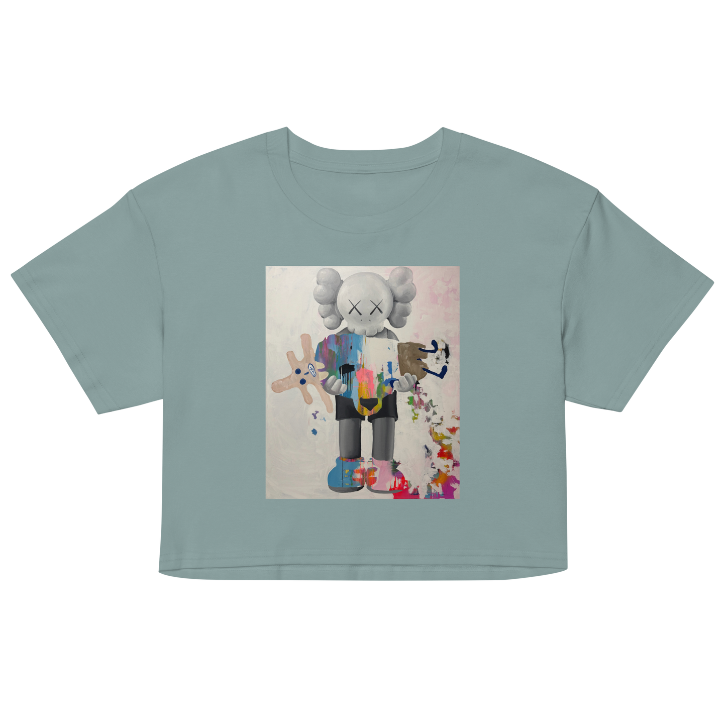 A sage green short-sleeve crop top t-shirt featuring a colorful graphic print of a stylized cartoon character with a white head and multicolored body. Daniel Maltzman artist.