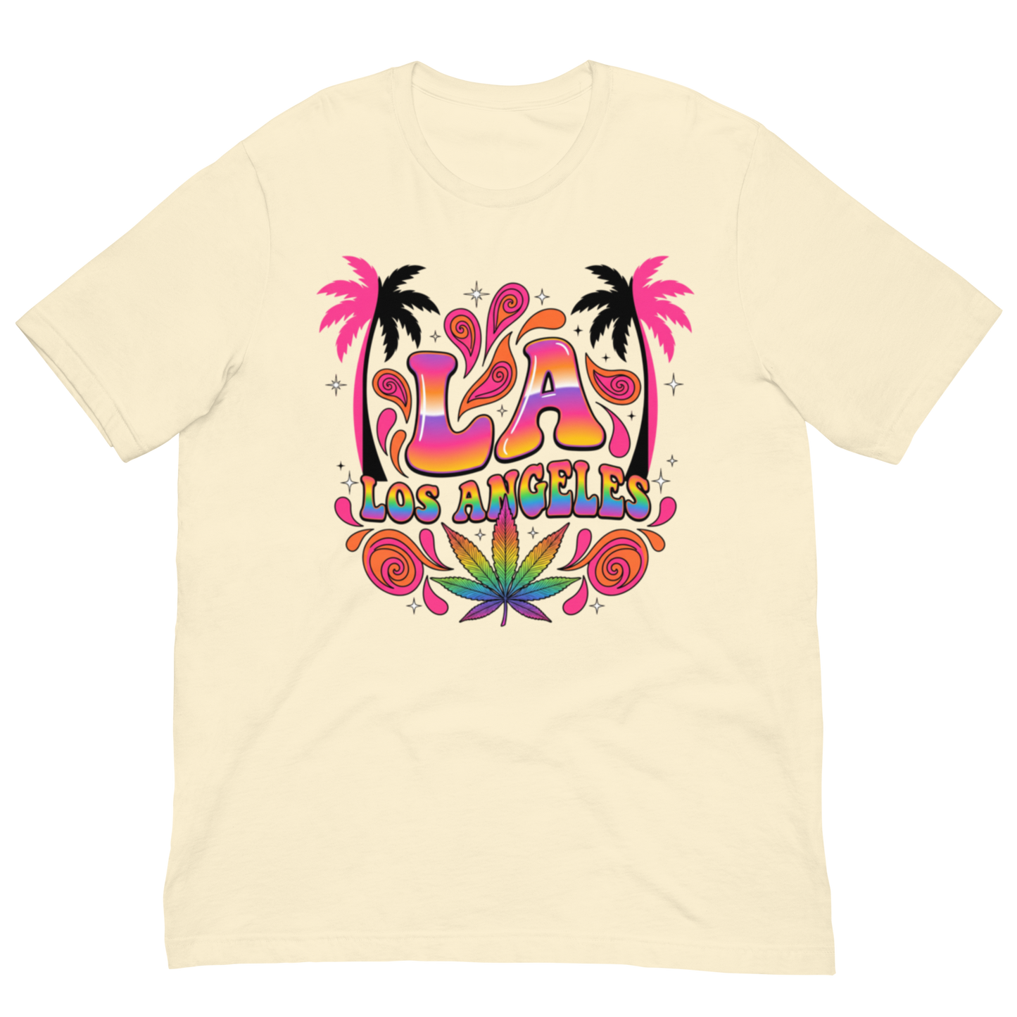 A cream-colored short-sleeve t-shirt with a colorful retro-style graphic on the chest featuring the text 'LA LOS ANGELES' in a rainbow gradient, flanked by pink palm trees and a green cannabis leaf.