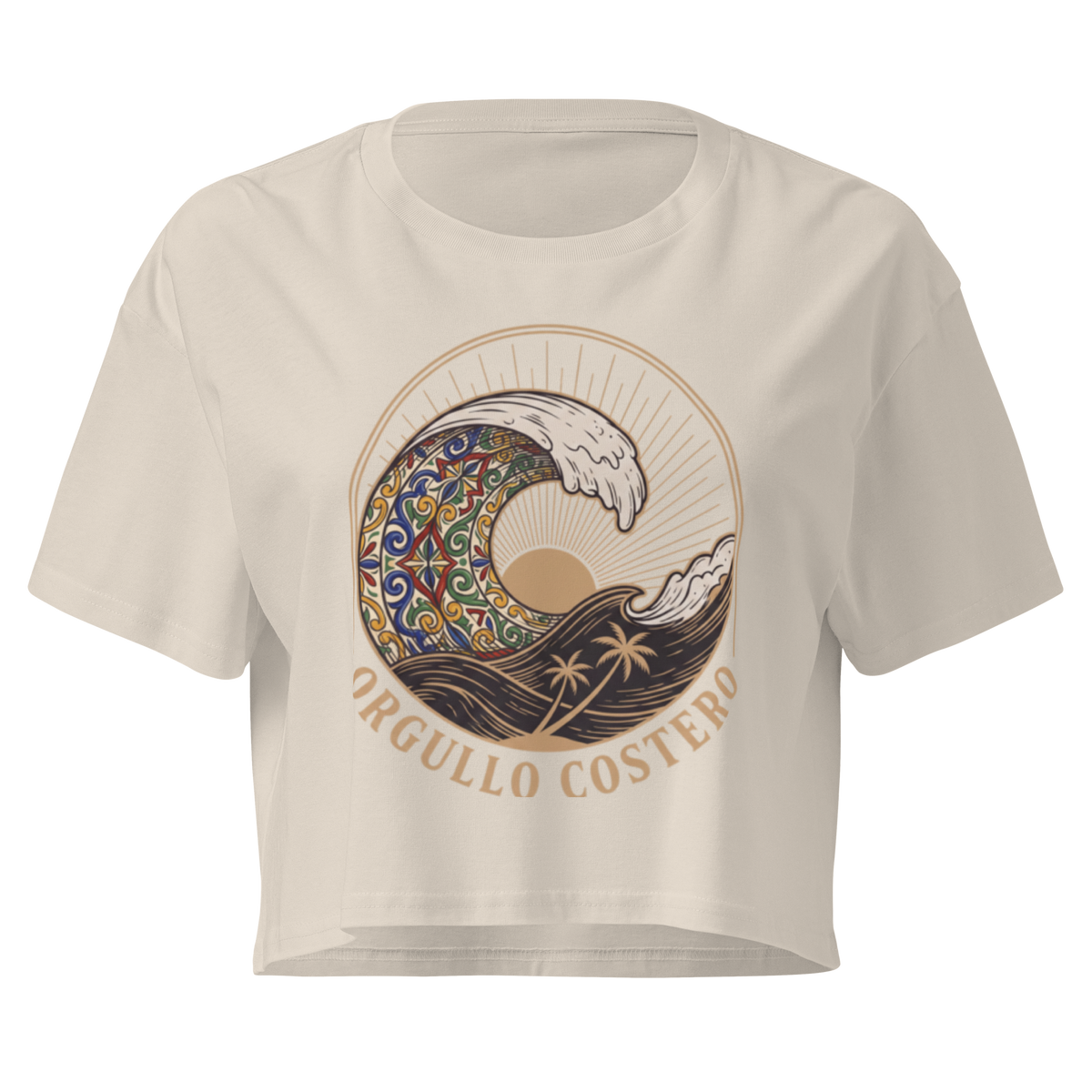 A cream-colored short-sleeve crop top featuring a large graphic print of a stylized wave with a mandala pattern, a sun, palm trees, and the text 'ORGULLO COSTERO' printed below.
