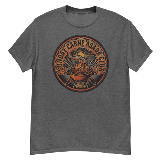 A heather dark gray crewneck t-shirt featuring a circular graphic print on the chest. The graphic depicts a steaming barbecue grill with crossed utensils, a sun, and the text 'SUNDAY CARNE ASADA CLUB' in a warm orange and brown color palette.