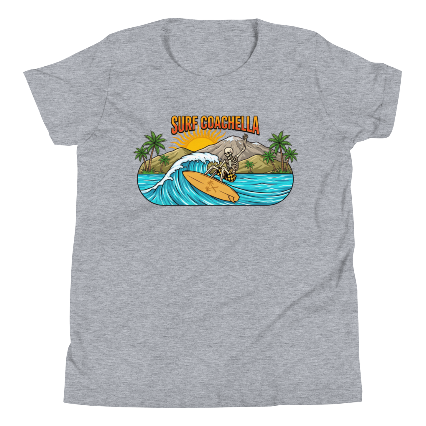 A heather gray short-sleeve t-shirt with a colorful graphic print on the chest. The graphic features the text 'SURF COACHELLA' in orange, above an illustration of a skeleton surfing on a yellow board amidst blue waves, green palm trees, and a mountain under a yellow sun.