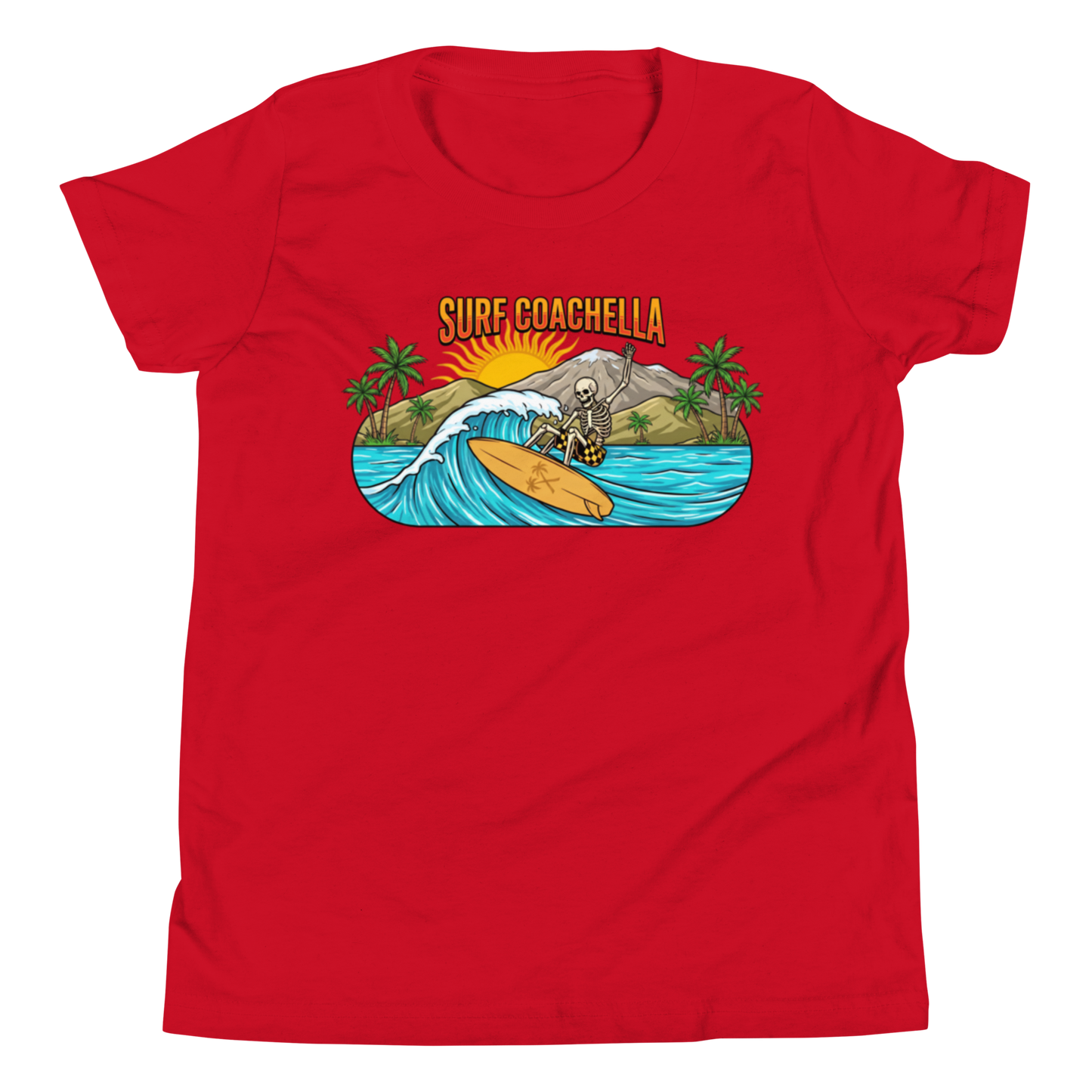 A red short-sleeve crewneck t-shirt featuring a colorful graphic print on the chest. The graphic depicts a skeleton surfer riding a wave with palm trees, a mountain, and the text 'SURF COACHELLA' in yellow.