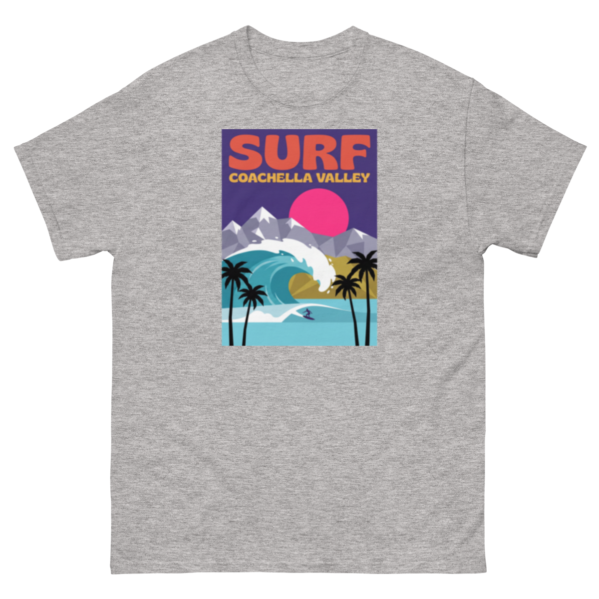 A heather gray short-sleeve t-shirt with a colorful retro graphic on the chest that reads 'SURF COACHELLA VALLEY' above an illustration of mountains, a pink sun, palm trees, and a surfer.