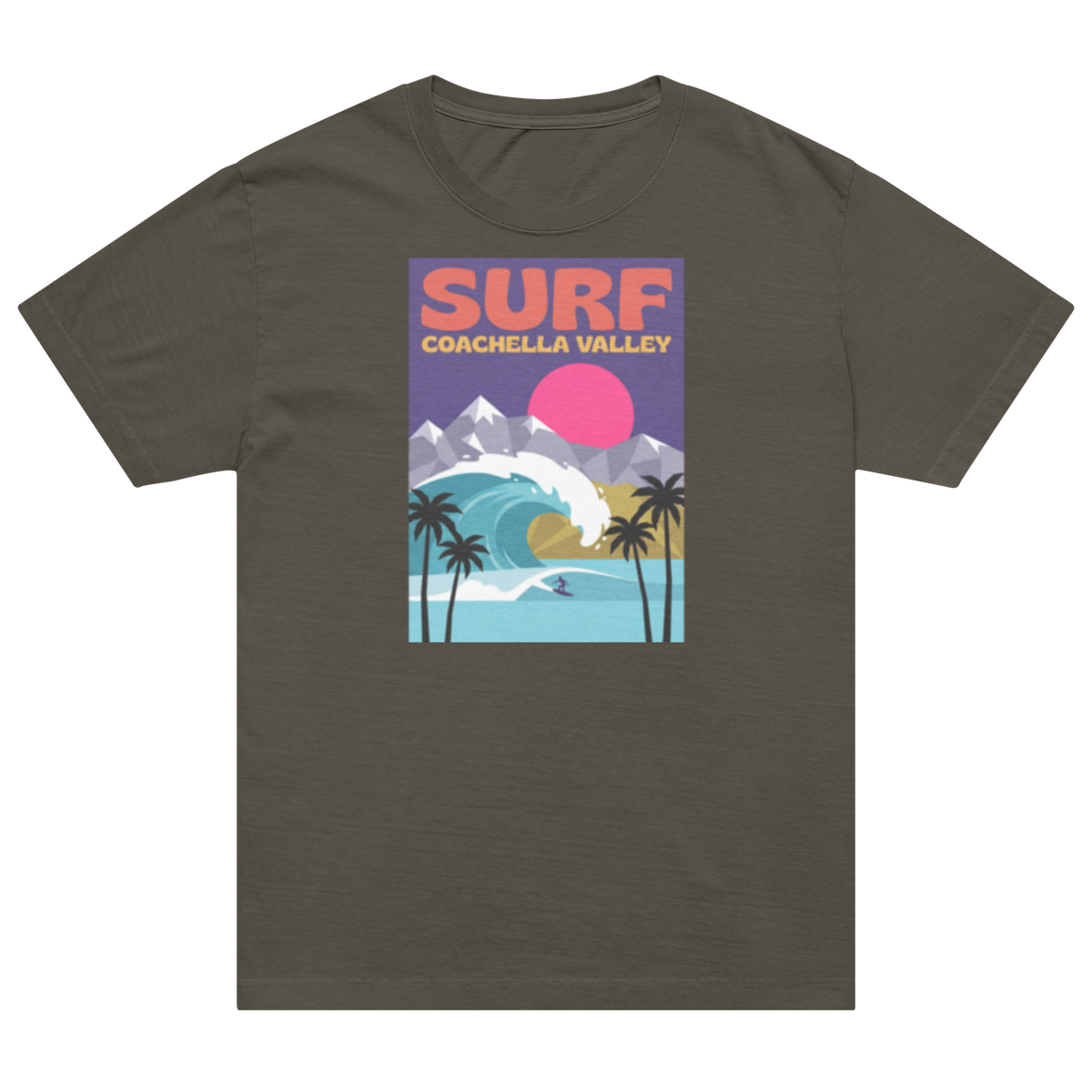 A dark olive green short-sleeve t-shirt with a colorful retro graphic on the chest that reads 'SURF COACHELLA VALLEY' above an illustration of a wave, mountains, palm trees, and a pink sun.
