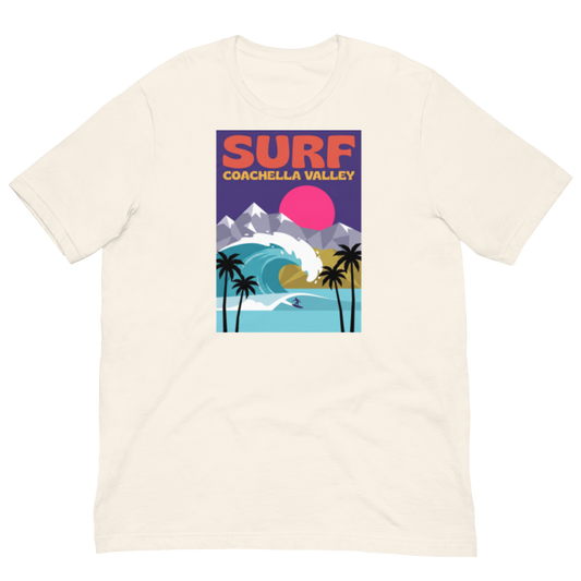 An off-white short-sleeve crewneck t-shirt featuring a colorful retro-style graphic print on the chest that reads 'SURF COACHELLA VALLEY' above an illustration of a wave, mountains, palm trees, and a pink sun.