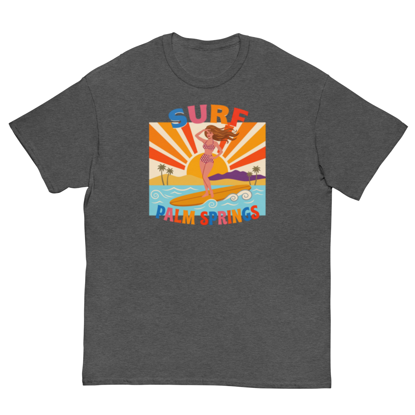 A dark heather gray crewneck t-shirt featuring a colorful retro graphic of a woman surfing on a beach with the text 'SURF PALM SPRINGS' in a wavy multicolor font.