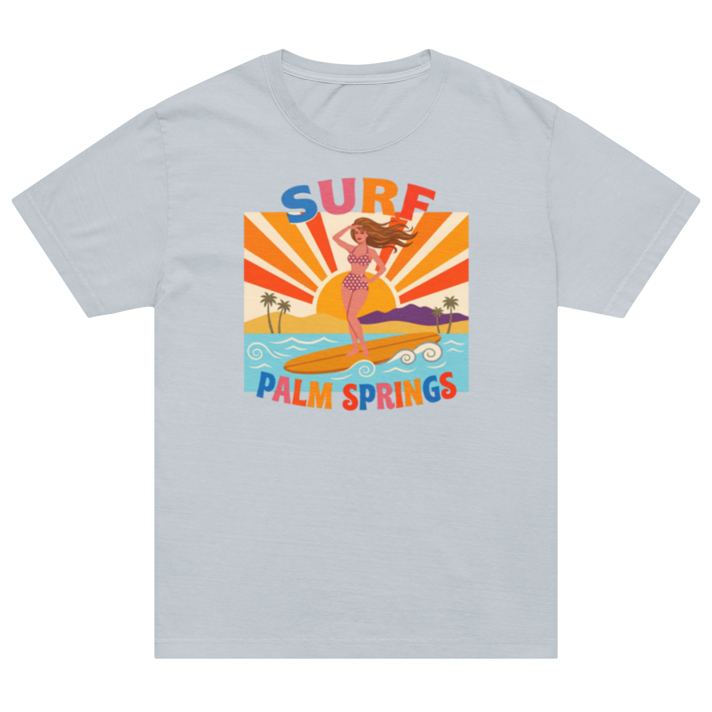 A light gray short-sleeve crewneck t-shirt featuring a colorful retro graphic of a woman surfing on a beach with palm trees and the text 'SURF PALM SPRINGS'.
