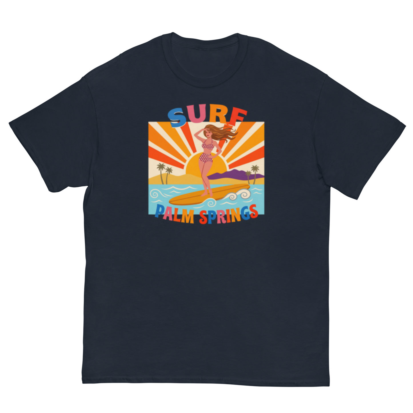 A navy blue short-sleeve crewneck t-shirt featuring a colorful retro graphic of a woman surfing on a beach with the text 'SURF PALM SPRINGS' in a stylized multicolor font.