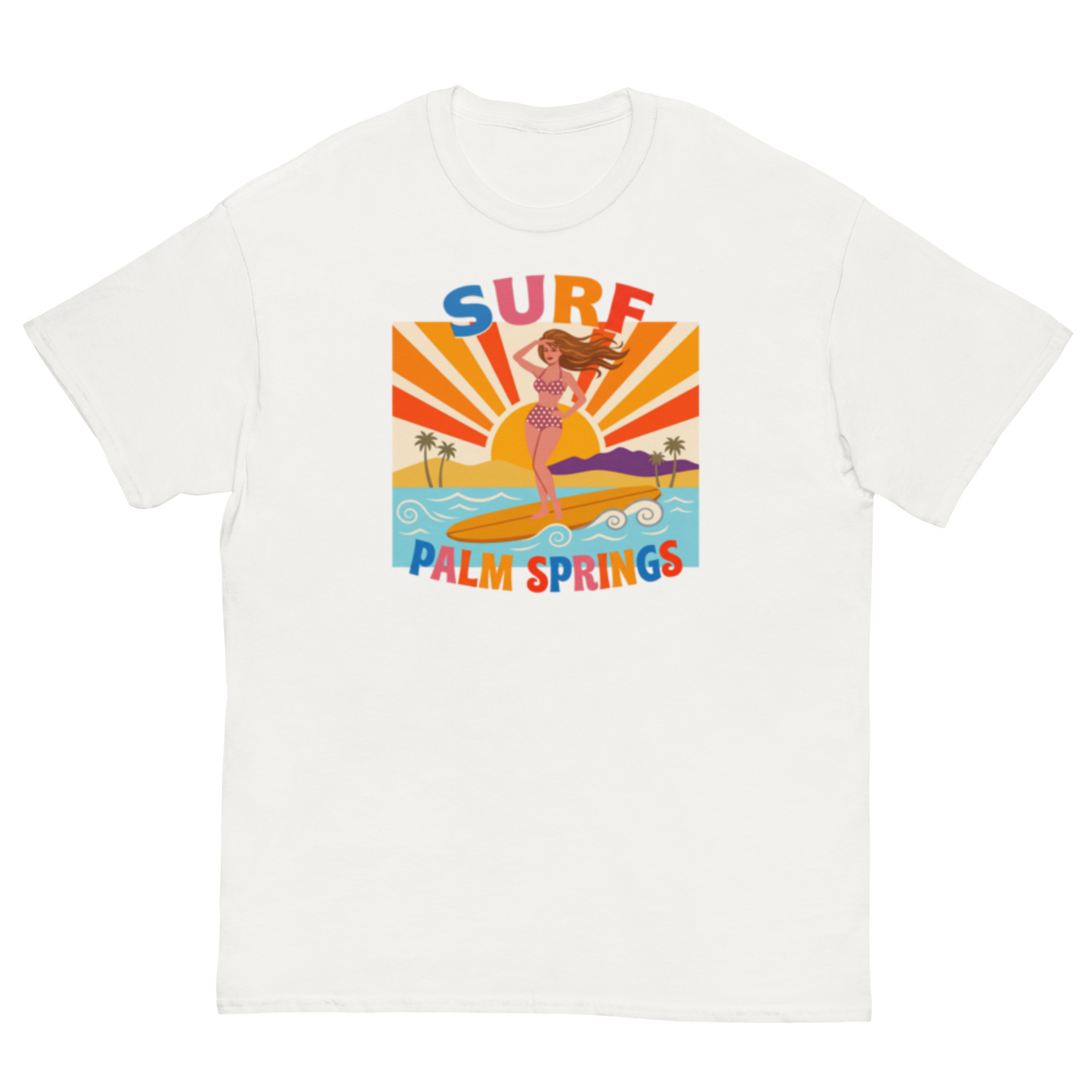 A white short-sleeve crewneck t-shirt featuring a colorful retro graphic of a woman surfing on a beach with the text 'SURF PALM SPRINGS' in stylized multicolor lettering.