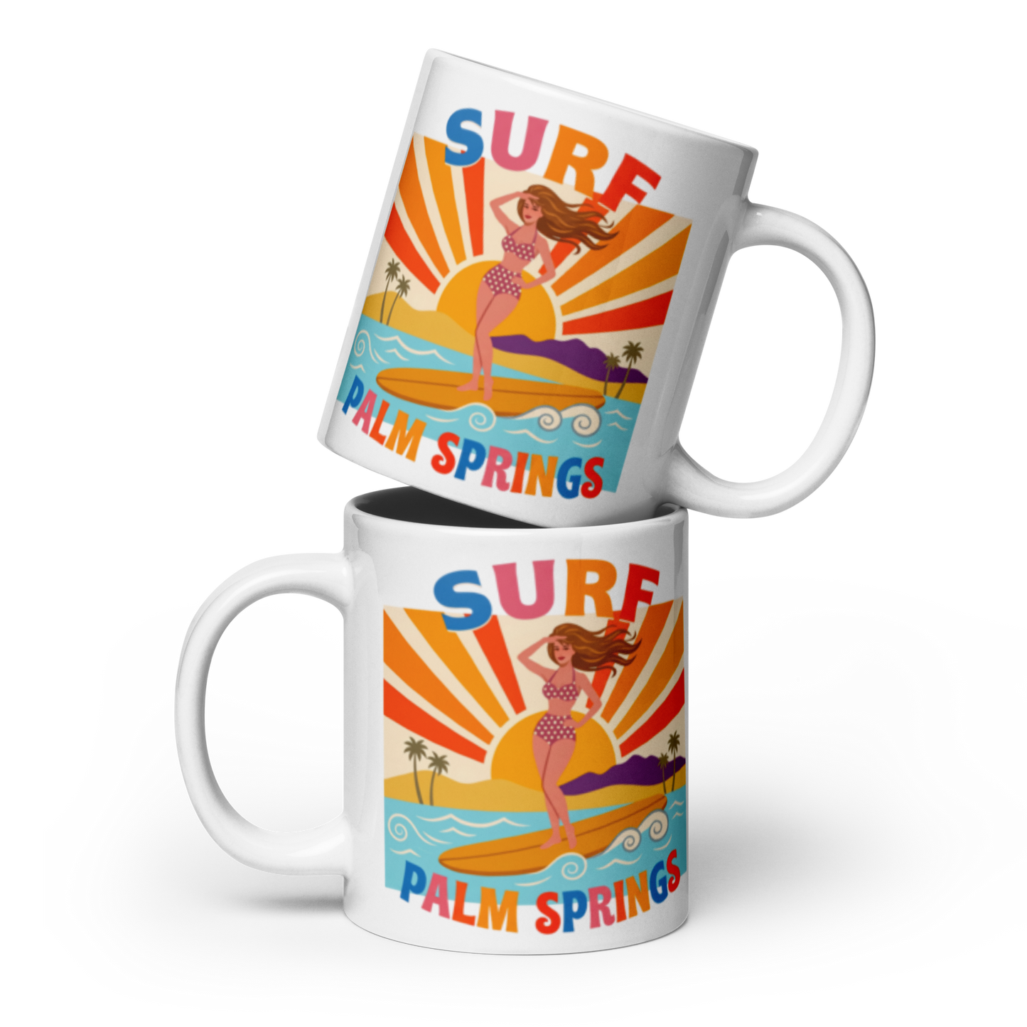 Two white ceramic mugs stacked with a retro surf graphic on a black background. The design features a woman in a bikini on a surfboard at sunset with the text 'SURF PALM SPRINGS'.