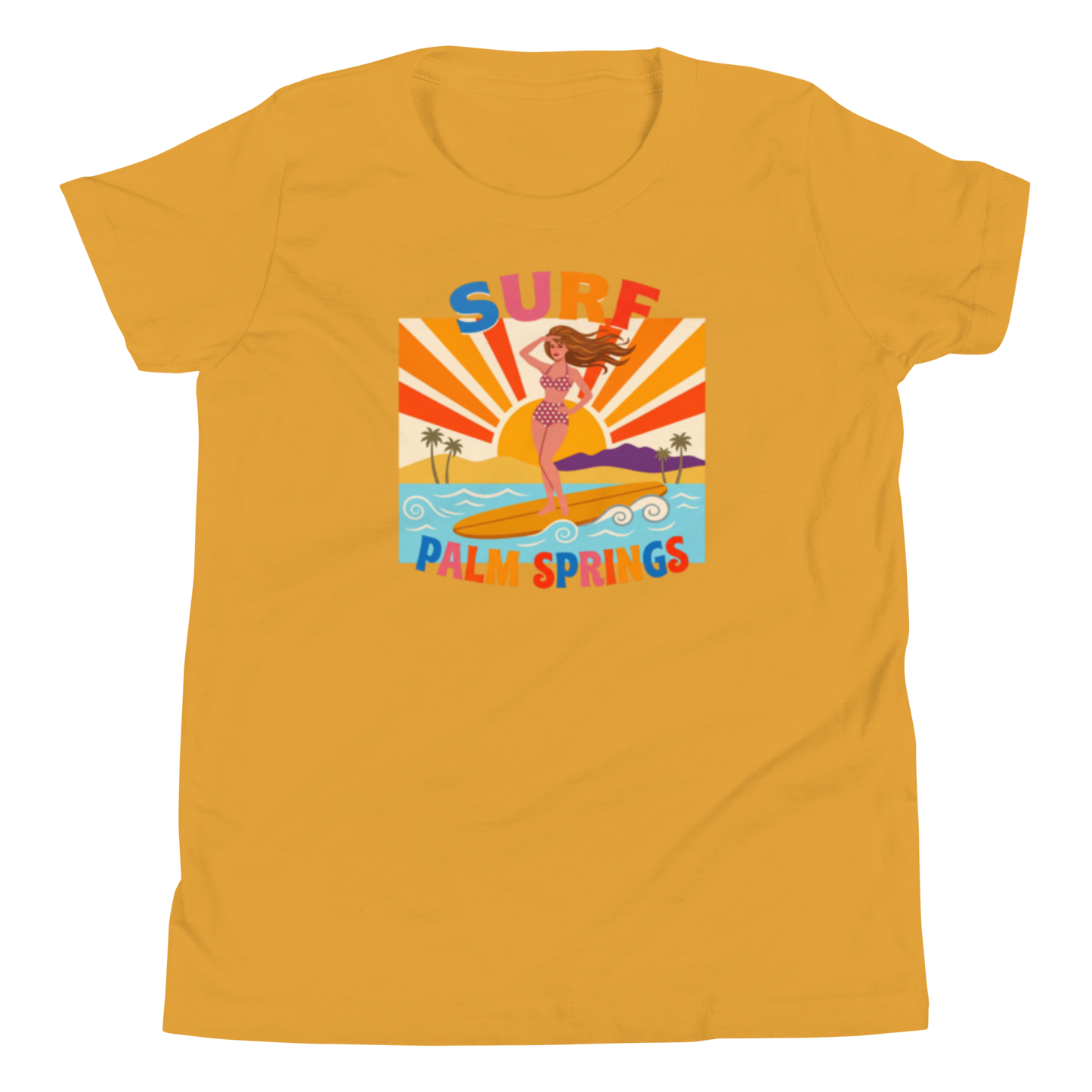 A mustard yellow short-sleeve t-shirt with a colorful retro graphic on the chest depicting a woman surfing with the text 'SURF PALM SPRINGS'.