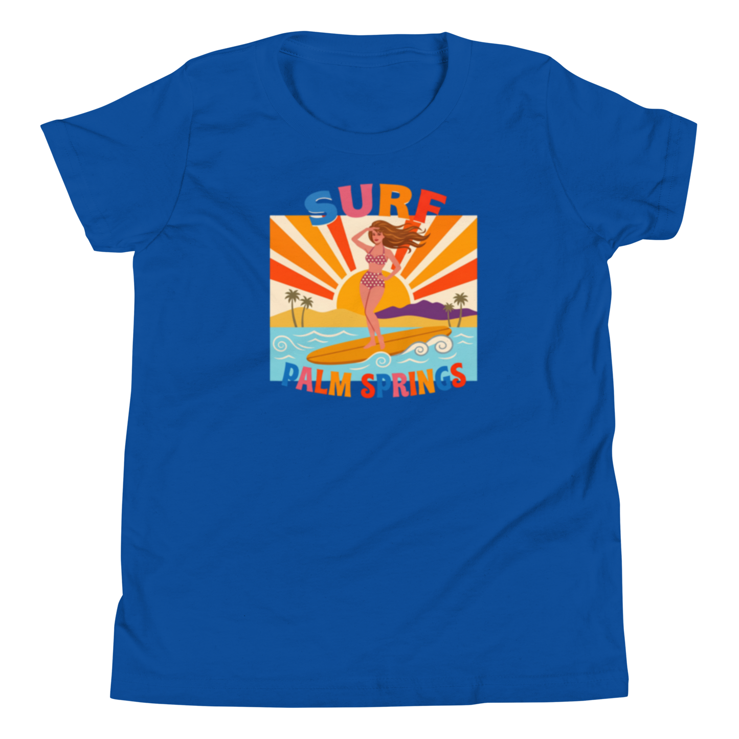A royal blue short-sleeve crewneck t-shirt featuring a retro-style graphic print of a mermaid surfing on a beach with the text 'SURF PALM SPRINGS'.
