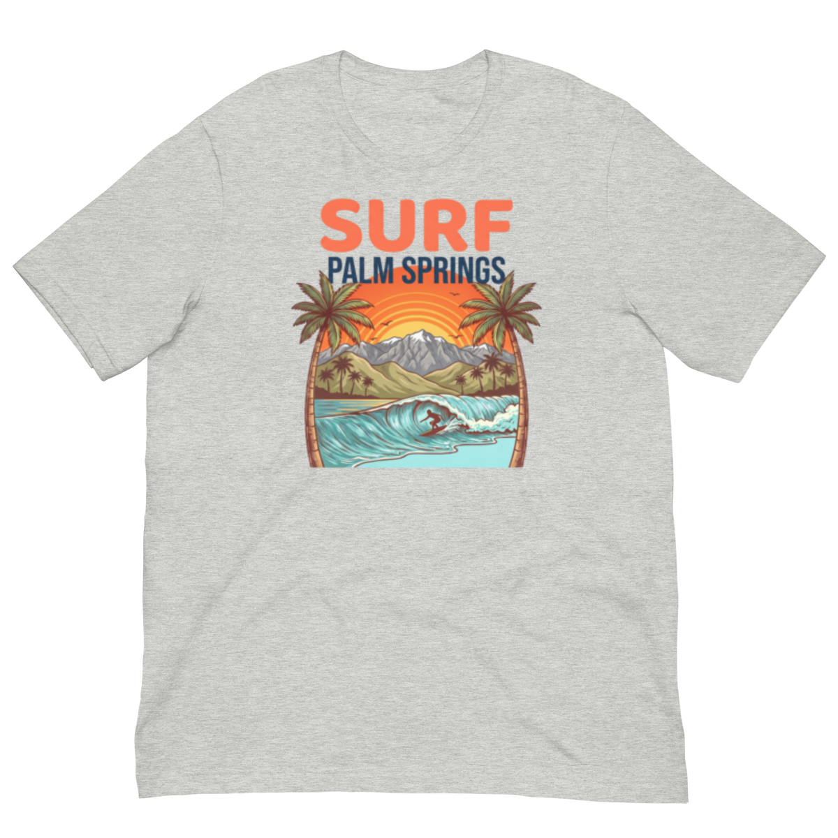 A light heather gray short-sleeve t-shirt with a retro-style graphic on the chest. The graphic features the text 'SURF PALM SPRINGS' in coral and navy blue, above an illustration of a surfer riding a wave with palm trees and mountains in the background.