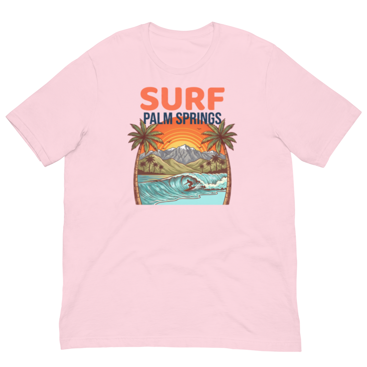 A light pink short-sleeve crewneck t-shirt featuring a colorful graphic print on the front with the text 'SURF PALM SPRINGS' above an illustration of palm trees, mountains, a beach, and a surfer riding a wave.