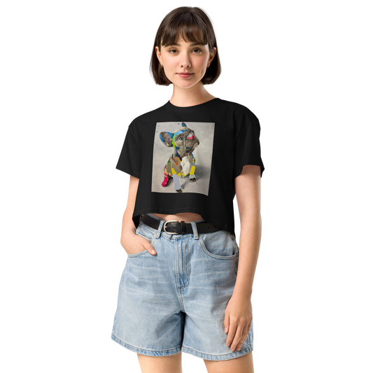 A woman modeling a black short-sleeve crop top t-shirt with a colorful geometric dog graphic on the front, paired with light-wash denim shorts, Daniel Maltzman artist.