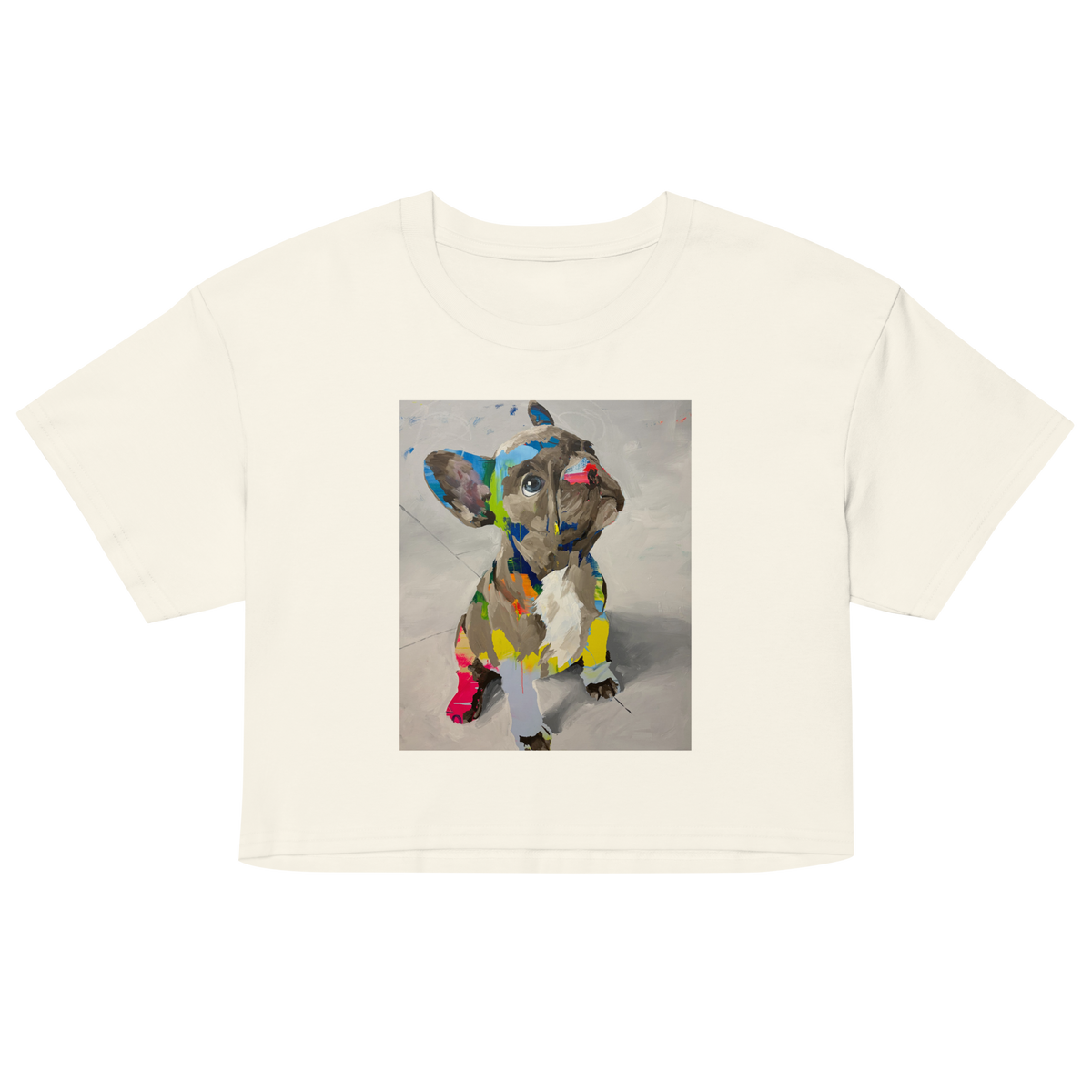 An off-white short-sleeve crop top t-shirt featuring a square graphic print of a French Bulldog wearing a colorful mosaic pattern. Daniel Maltzman design.