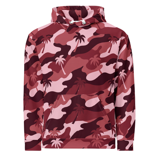 A pullover hoodie featuring a pink, red, and dark burgundy camouflage pattern overlaid with light pink palm tree silhouettes. The hoodie has a front kangaroo pocket and white drawstrings.
