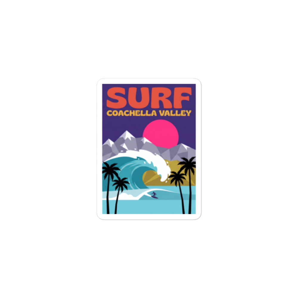 A rectangular sticker with rounded corners featuring a retro-style surf illustration labeled 'SURF COACHELLA VALLEY.' The design shows a large blue wave, white foam, black palm trees, gray mountains, a pink sun, and a small surfer on a light blue water area.