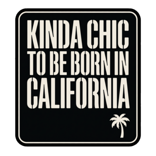 A square black sticker or sign with rounded corners featuring the phrase 'KINDA CHIC TO BE BORN IN CALIFORNIA' in large off-white stencil-style lettering, plus a small palm tree icon in the lower right.