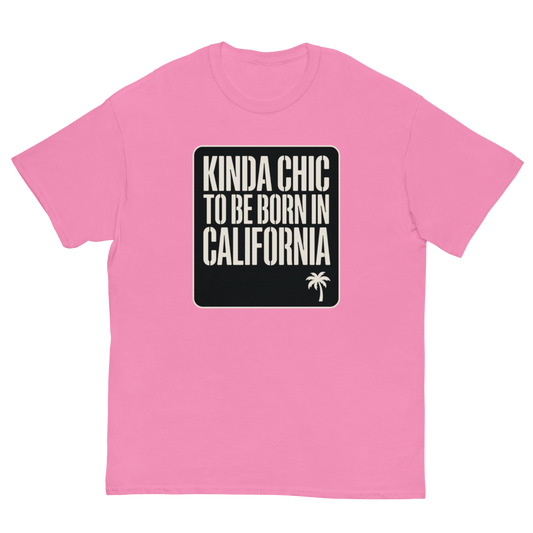 A pink short-sleeve crewneck t-shirt with a black square graphic on the chest containing the text 'KINDA CHIC TO BE BORN IN CALIFORNIA' in cream lettering and a small palm tree icon.