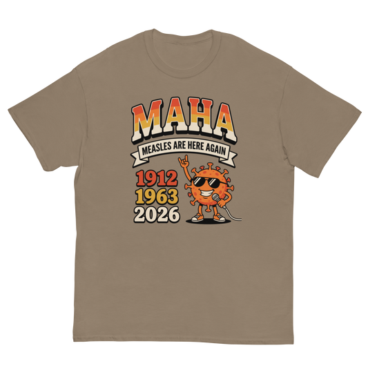 A taupe brown short-sleeve t-shirt with a graphic print on the front. The graphic features the text 'MAHA MEASLES ARE HERE AGAIN' above a cartoon orange virus character wearing sunglasses, with years '1912', '1963', and '2026' listed below.
