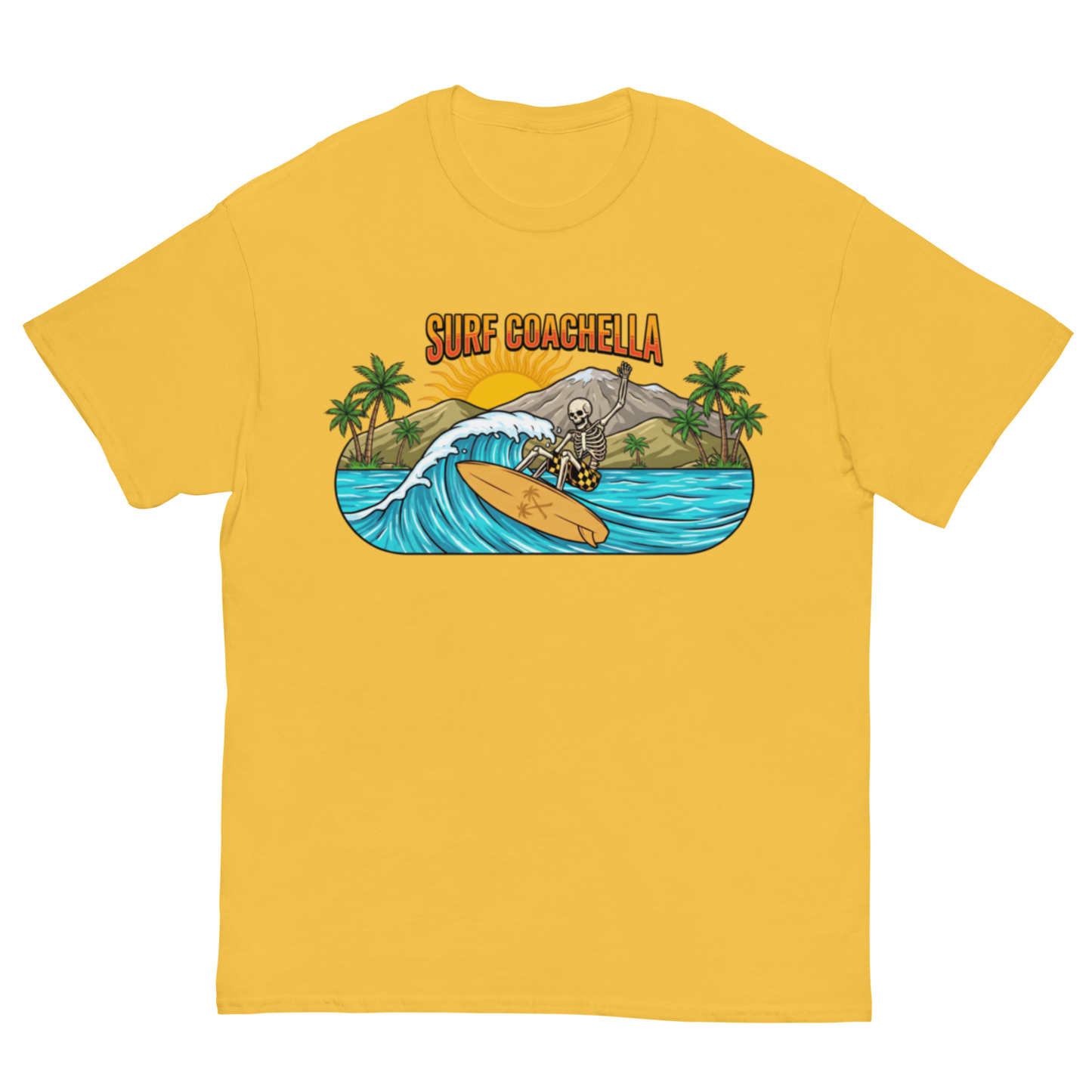 A yellow short-sleeve crewneck t-shirt featuring a colorful graphic print on the chest. The graphic shows a skeleton surfer riding a wave on a beach with palm trees and the text 'SURF COACHELLA' in orange.