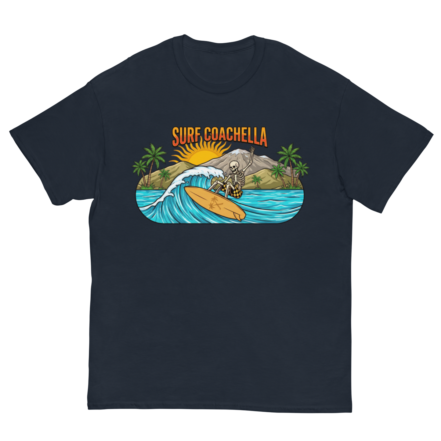 A navy blue short-sleeve crewneck t-shirt featuring a colorful graphic print on the front. The graphic shows a skeleton surfer riding a wave on a yellow surfboard, with palm trees, mountains, a yellow sun, and the text 'SURF COACHELLA' in orange above.
