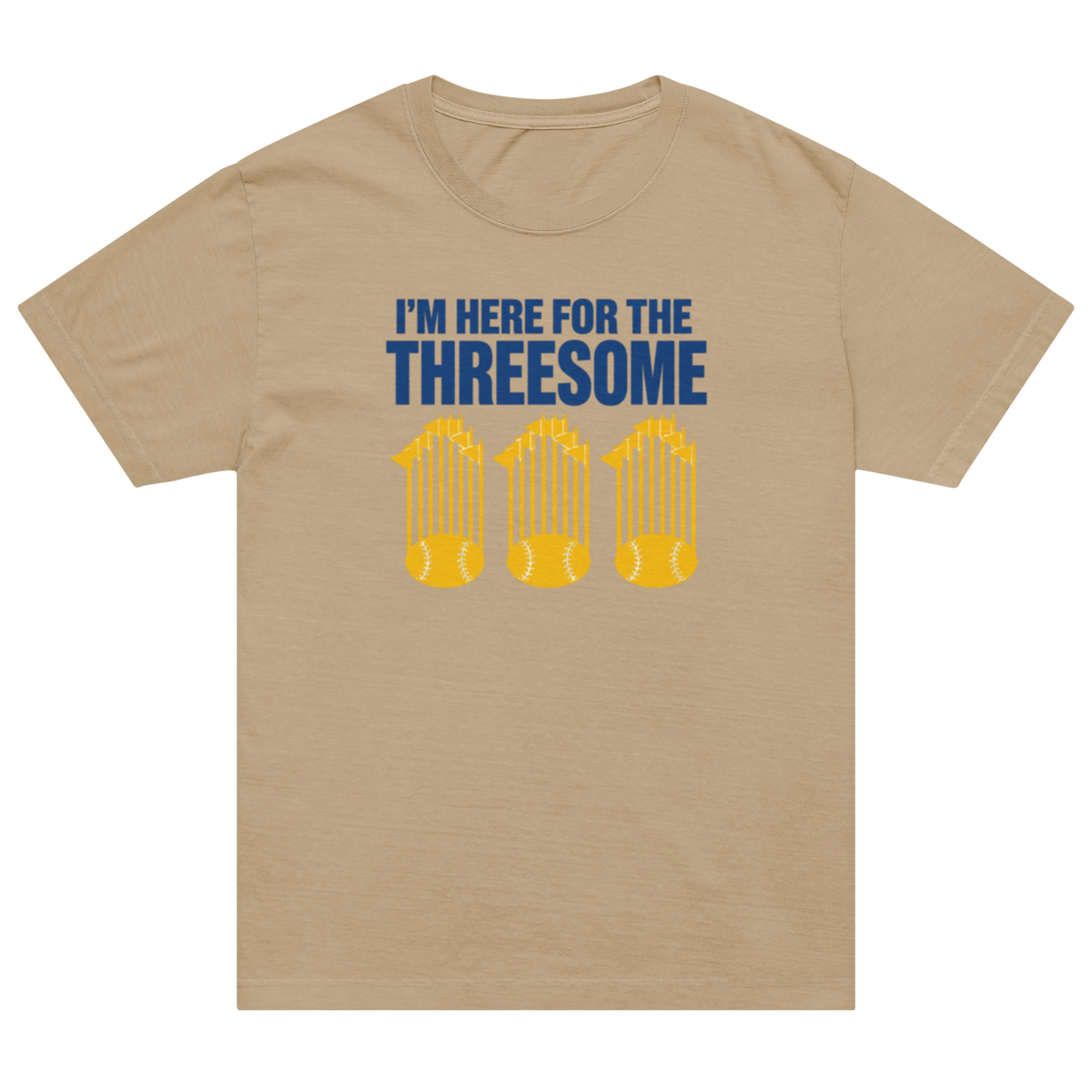 A beige crewneck t-shirt with a graphic print on the front. The print features the text 'I'M HERE FOR THE THREESOME' in dark blue, above three yellow baseball bats.