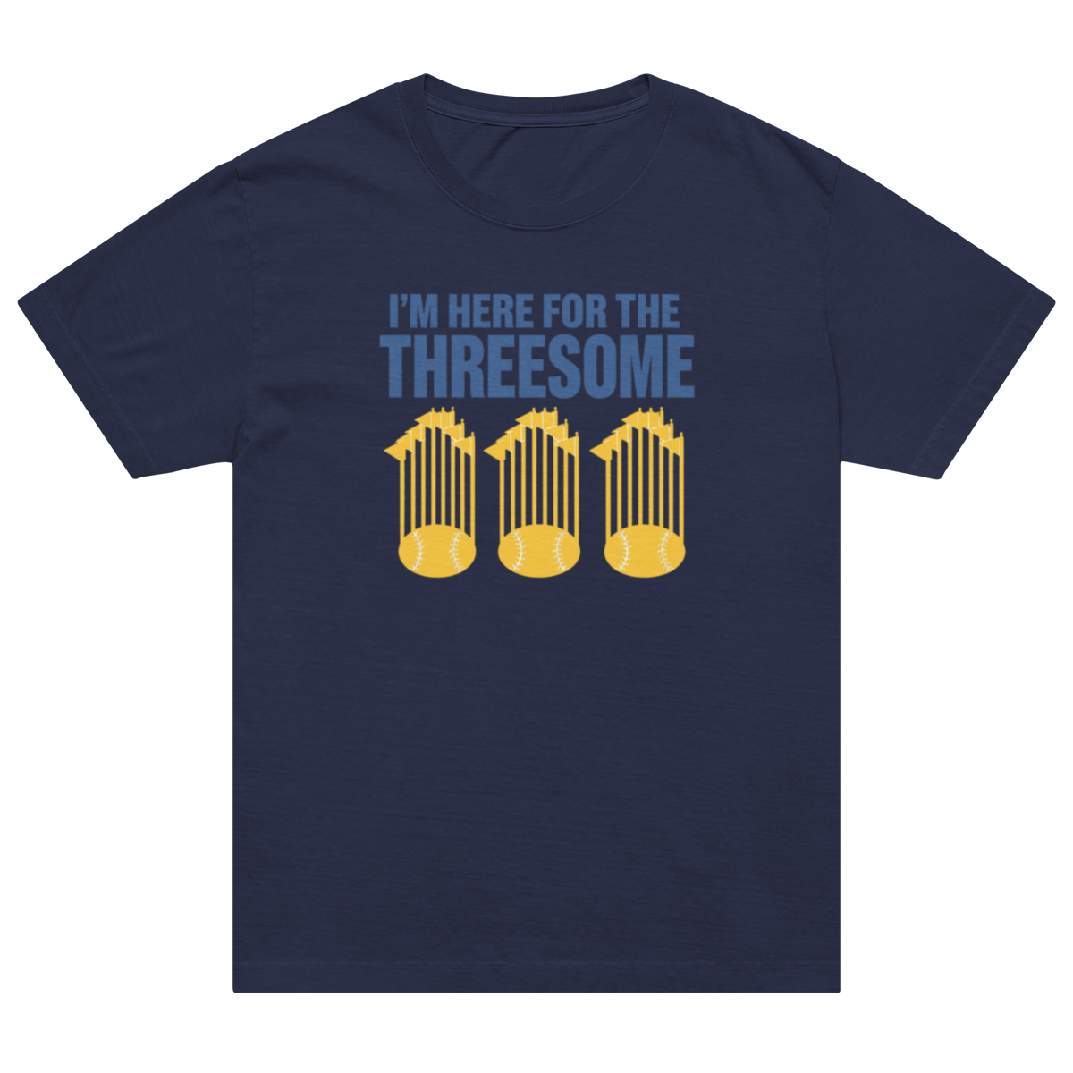 A navy blue short-sleeve t-shirt with a graphic on the chest that reads 'I'M HERE FOR THE THREESOME' in light blue text above three yellow baseball cages, shown on a plain white background.