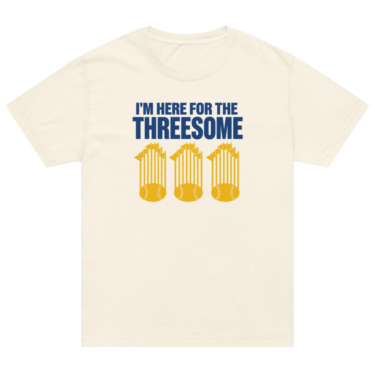 An off-white short-sleeve crewneck t-shirt featuring a graphic print of three gold baseballs under the text 'I'M HERE FOR THE THREESOME' in navy blue.