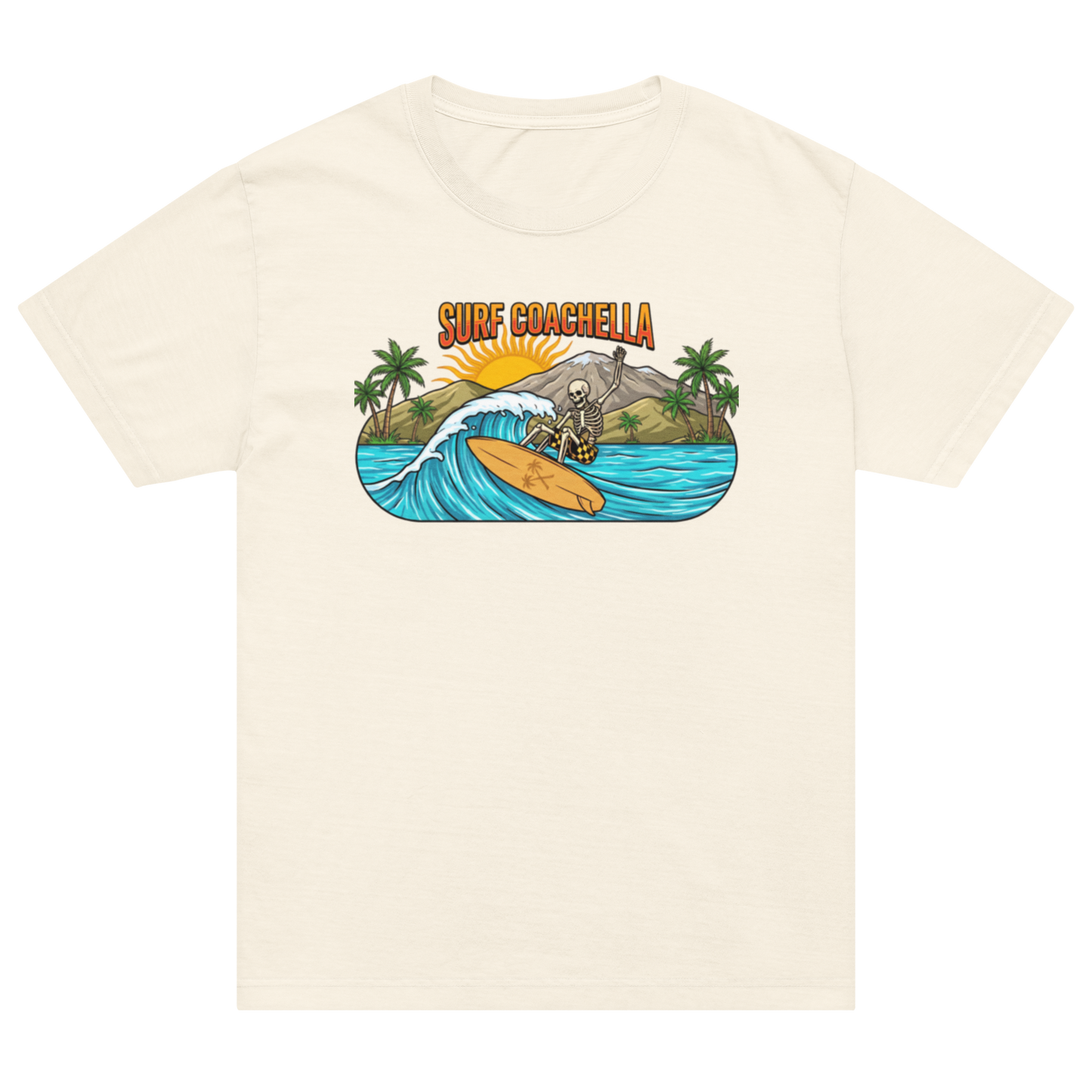 An off-white short-sleeve crewneck t-shirt featuring a colorful graphic print on the chest. The graphic depicts a skeleton surfing on a yellow board on a turquoise wave, with green palm trees, a gray cliff, and the text 'SURF COACHELLA' in orange above.