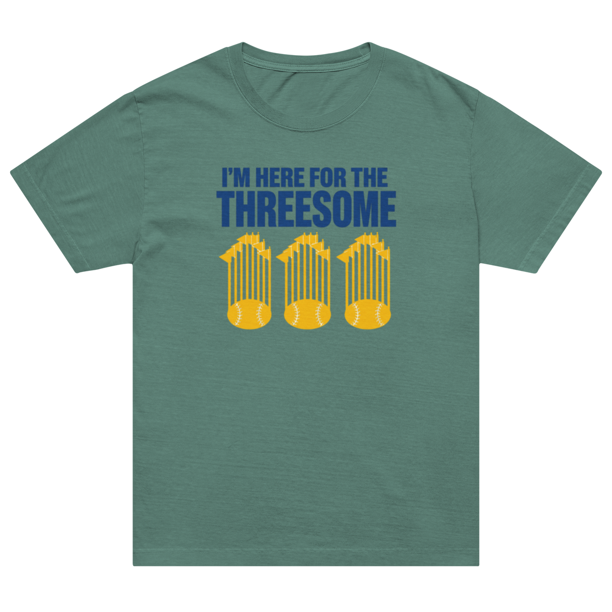 A sage green crewneck t-shirt with a graphic on the chest that reads 'I'M HERE FOR THE THREESOME' in blue, above three yellow baseball cages containing baseballs.