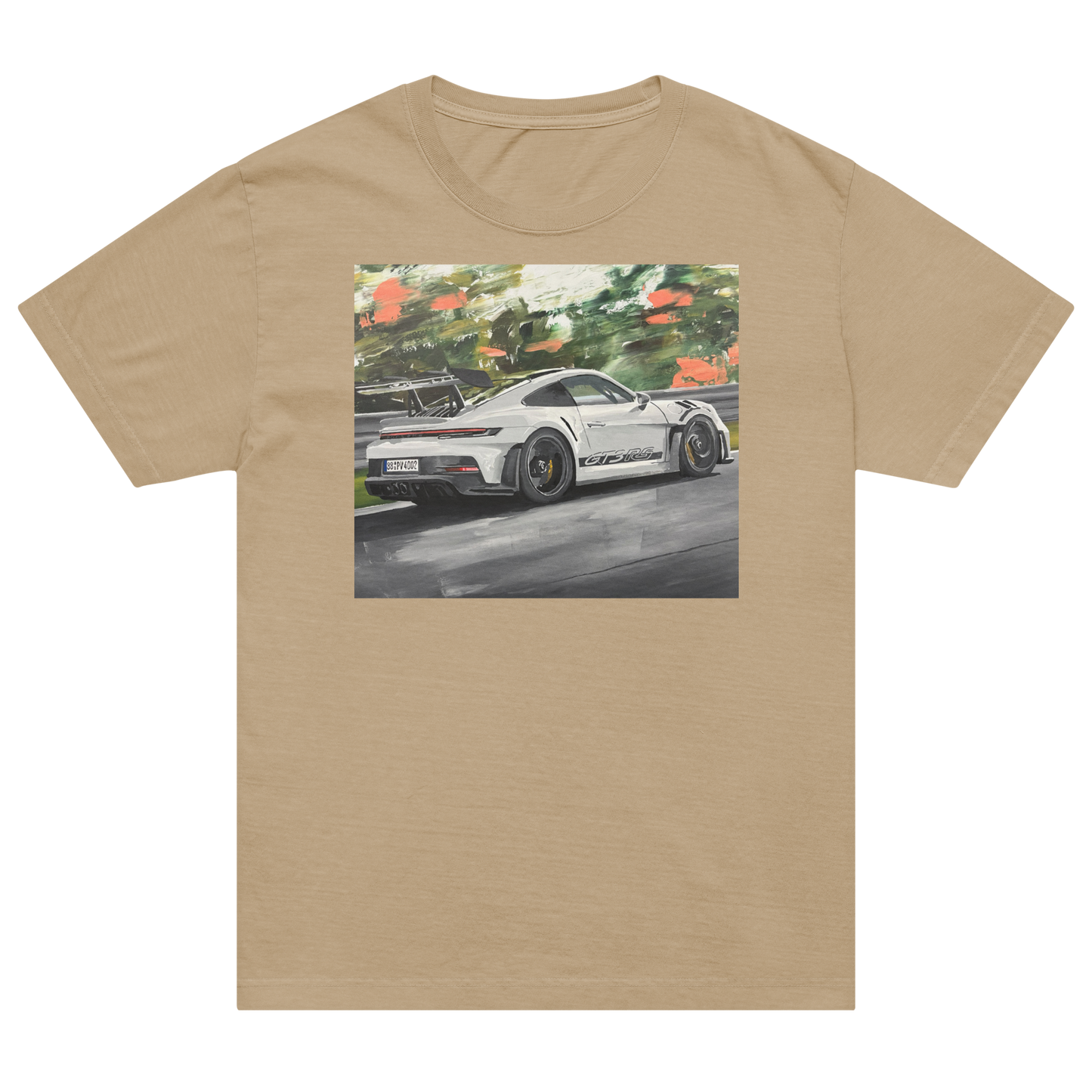 A beige short-sleeve crewneck t-shirt featuring a rectangular graphic print of a white sports car on a racetrack with green trees and orange flowers in the background. Daniel Maltzman artist.