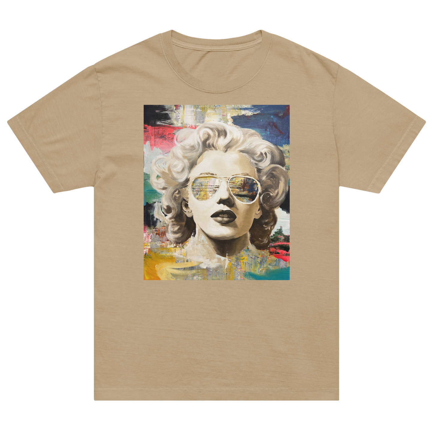 A beige short-sleeve crewneck t-shirt featuring a colorful graphic print of Marilyn Monroe wearing aviator sunglasses, displayed against a solid white background. Daniel Maltzman artist.